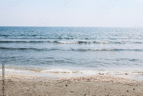 black sea sand pebbles water beach sunny