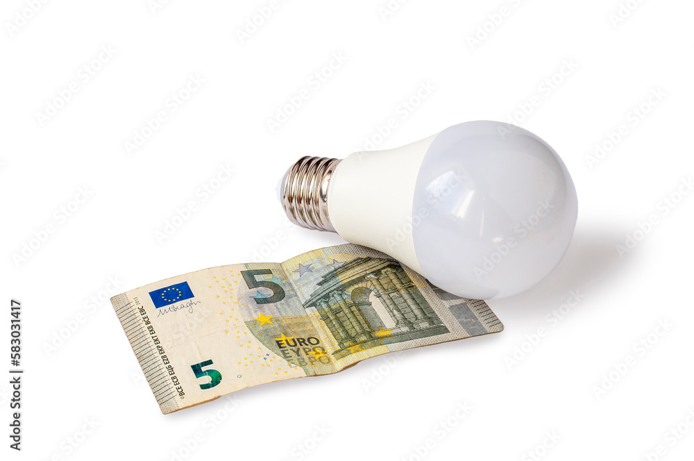 February 16, 2023. Sumy, Ukraine. An LED bulb rests on a 5-euro bill. The cost of electricity February 16, 2023. Sumy, Ukraine. An LED bulb rests on a 5-euro bill. The cost of electricity