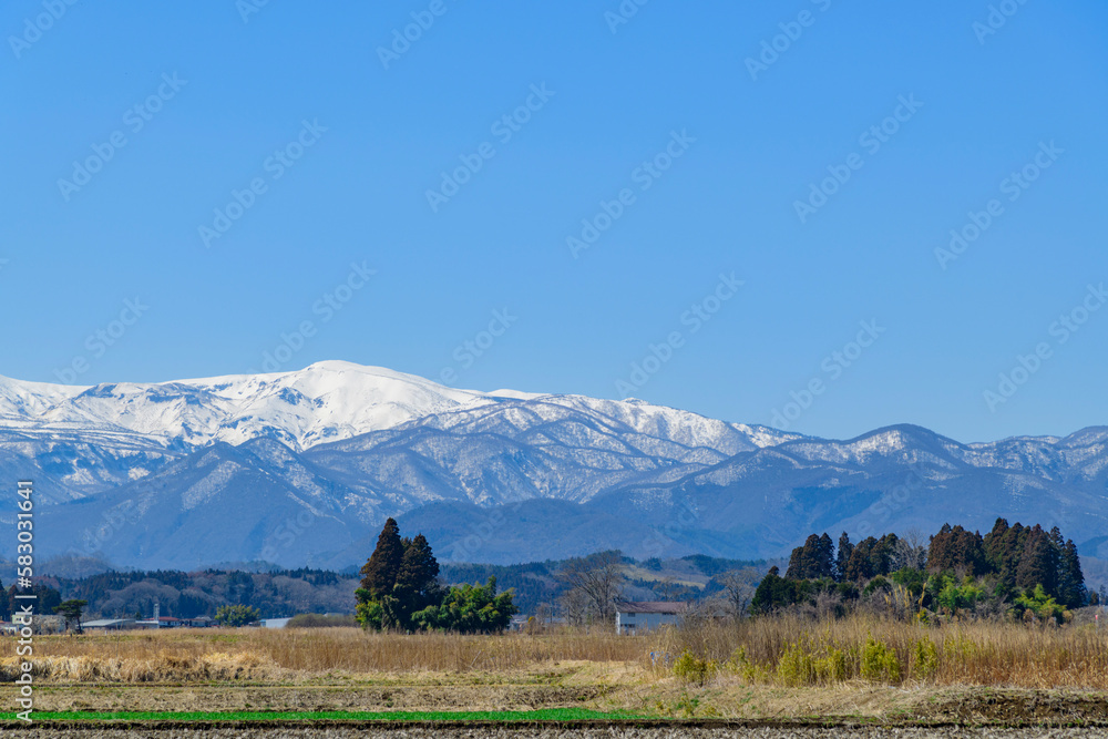 春を待つ蔵王と宮城の田園地帯
