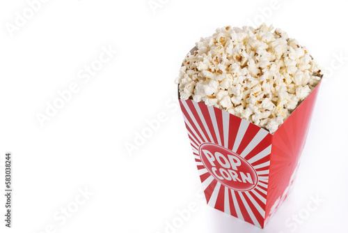 Popcorn in red and white striped cardboard bucket isolated on white background. Copy space