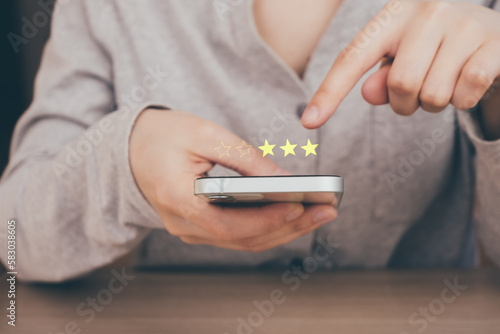Business woman touching and doing mark to three yellow stars on virtual touch screen. feedback rating and positive customer review, experience, satisfaction survey concept.