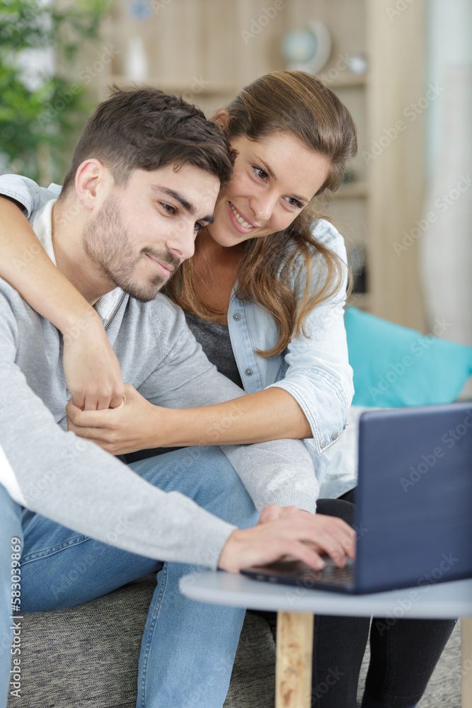 happy couple at home using a computer happy couple at home using a computer