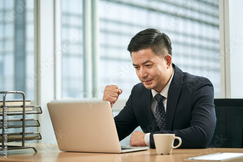 Photography asian business man working in office using laptop computer