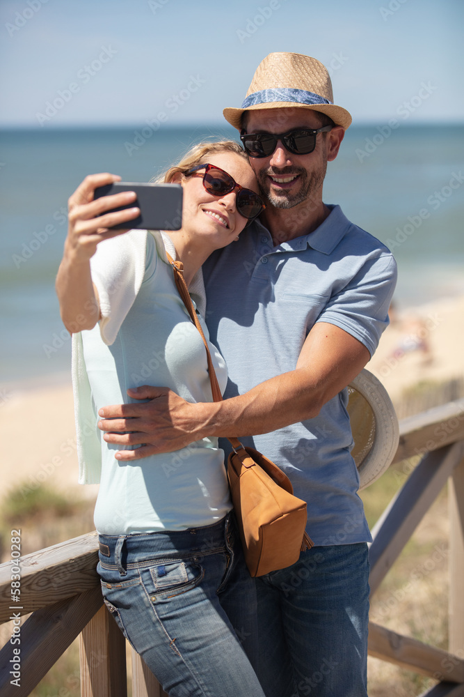 couple in love making selfie photo at the seaside