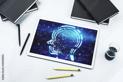 Creative artificial Intelligence concept with human head hologram on modern digital tablet screen. Top view. 3D Rendering