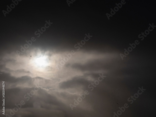 Dark and dramatic sky with sun. Abstract background for design.