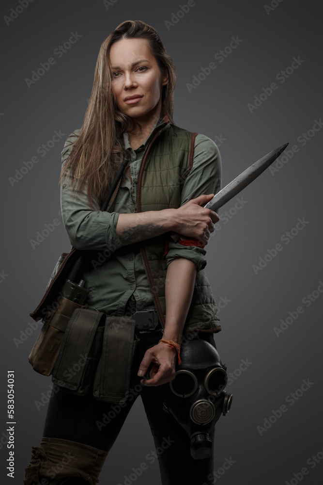 Portrait of dangerous female killer with knife in style of post apocalypse.