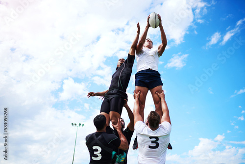 Great team mates help you reach your goals. a group of young men playing a game of rugby. photo