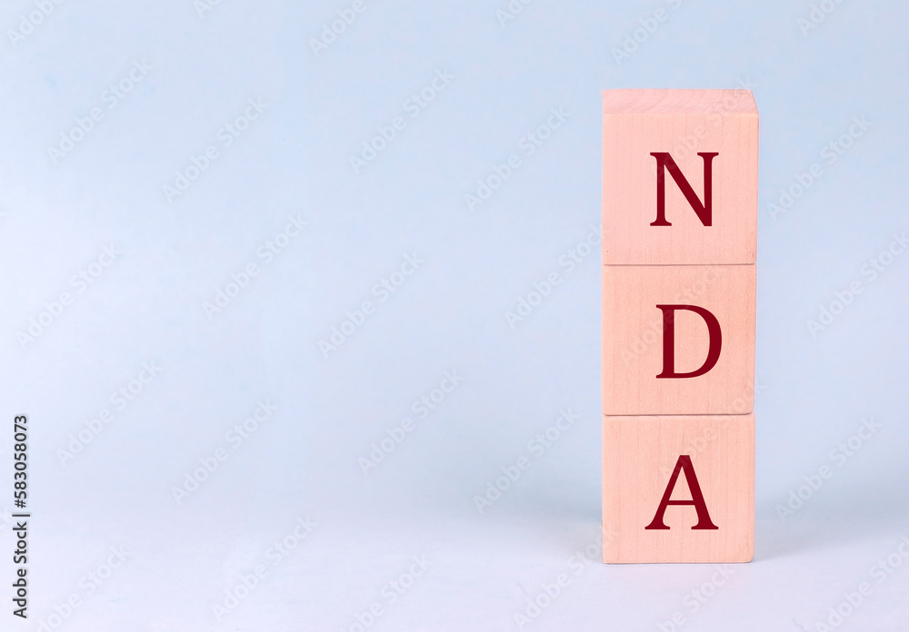 NDA on wooden cubes on a blue background NDA on wooden cubes on a blue background