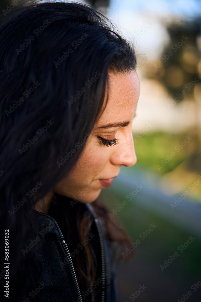 portrait close up of young brunette motorbike rider woman
