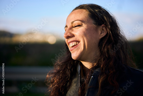 portrait of young smiling brunette motorbike rider woman