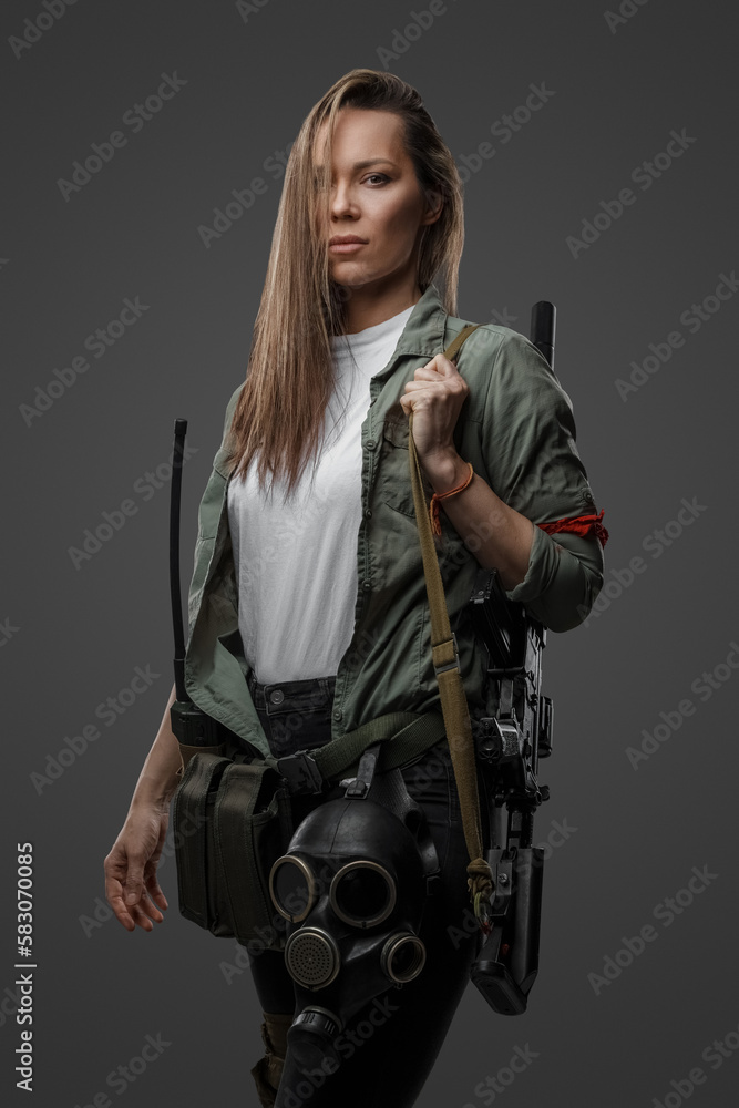 Portrait of killer woman with rifle in post apocalyptic style against gray background. Portrait of killer woman with rifle in post apocalyptic style against gray background.