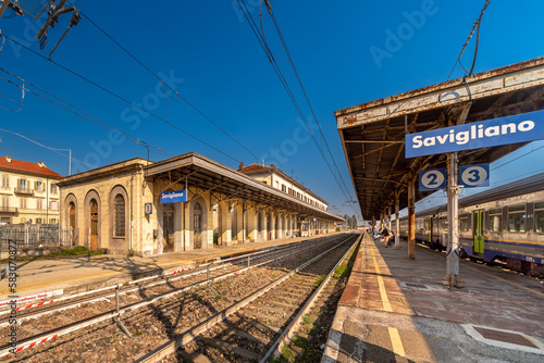 Savigliano, Cuneo, Italy - Trenitalia railway station with tracks and platforms on the line between Turin and Savona with blue sky