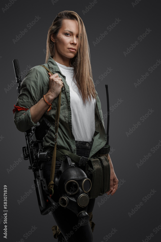 Portrait of killer woman with rifle in post apocalyptic style against gray background. Portrait of killer woman with rifle in post apocalyptic style against gray background.