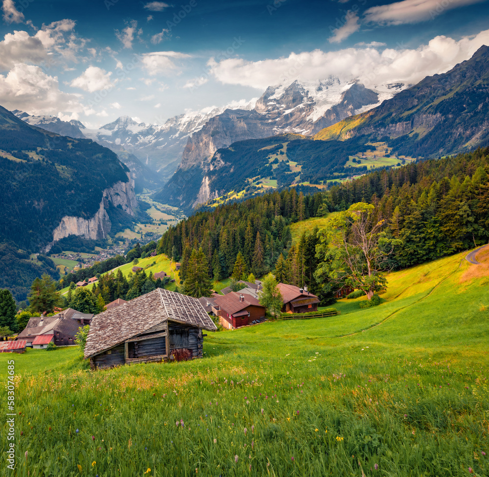 Wengen village in June. Amazing summer scene of Swiss Alps, Bernese Oberland in the canton of Bern, Switzerland, Europe. Beauty of countryside concept background..