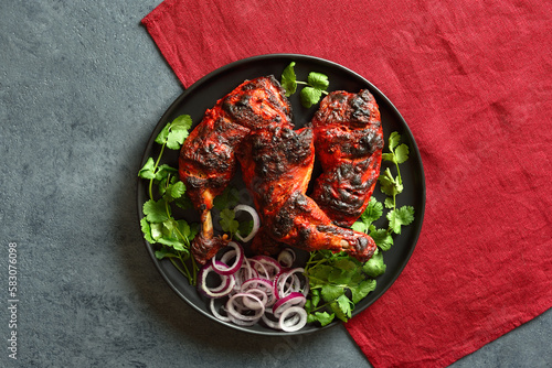 Tandoori chicken served with cilantro and onion