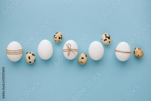 Composition with Easter eggs on blue background. Minimal easter concept.