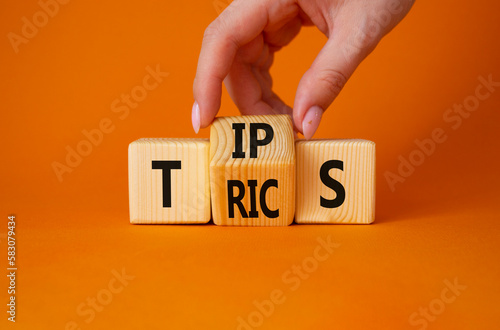 Wallpaper Mural Tips and Tricks symbol. Businessman Hand turns cubes and changes word Tricks to Tips. Beautiful orange background. Business and Tips and Tricks concept. Copy space Torontodigital.ca