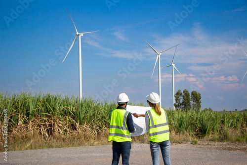 engineer team working in wind turbine farm. Renewable energy with wind generator by alternative energy concept.