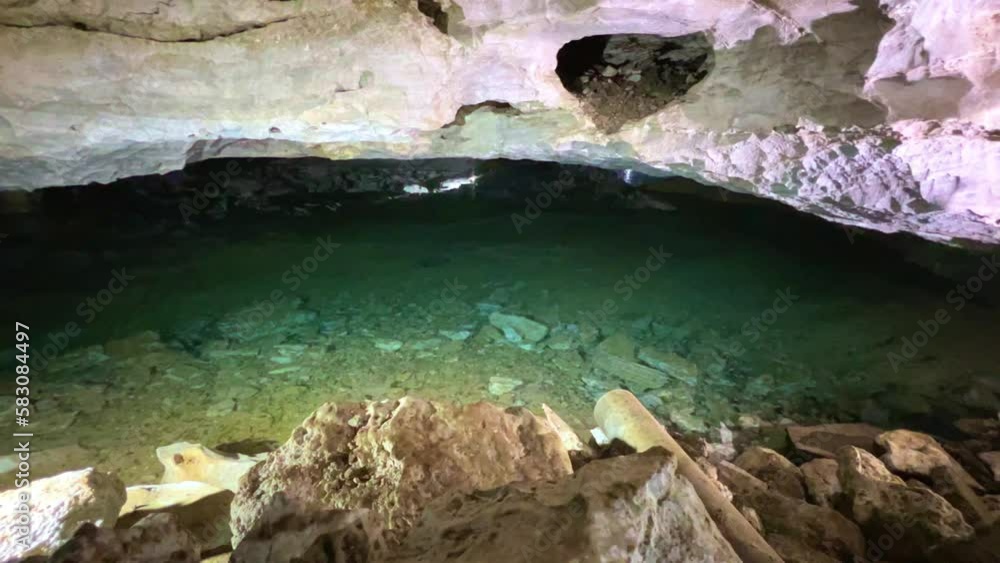 Excursion to the dark ice cave in winter. Underground large stone cave ...