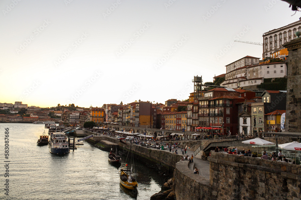 View of the river port of Porto, Portugal, at sunset with boats