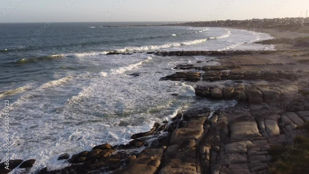 Drone flying over rocky coast of Punta del Diablo in Uruguay. Aerial forward Drone flying over rocky coast of Punta del Diablo in Uruguay. Aerial forward