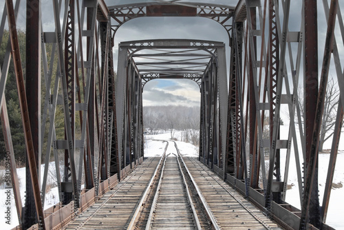 Old iron railway truss bridge built in 1893 crossing the Mississippi river in winter in Galetta, Ontario, Canada