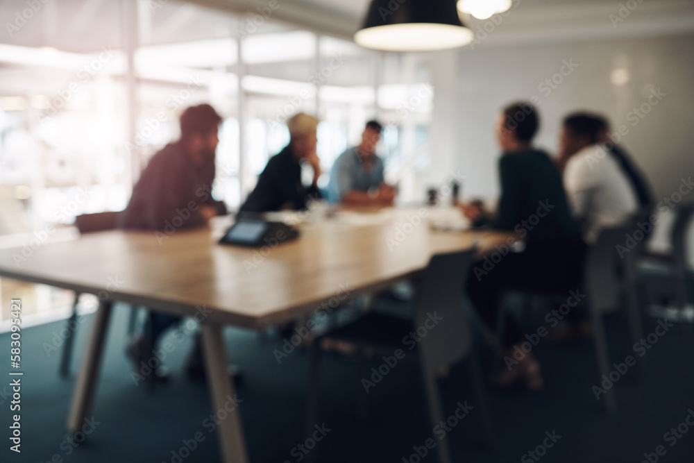 Meeting in session. a group of business colleagues sitting around a table in the boardroom during a meeting. Meeting in session. a group of business colleagues sitting around a table in the boardroom during a meeting.