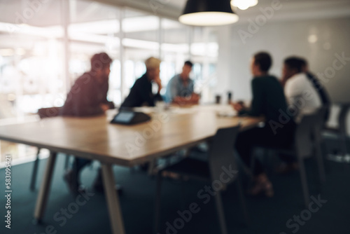 Meeting in session. a group of business colleagues sitting around a table in the boardroom during a meeting.