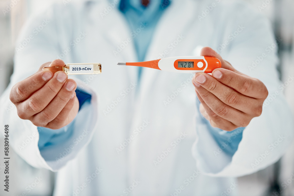 Fight off the infection with this. a scientist holding an ampoule with 2019-nCov on it and a thermometer. Fight off the infection with this. a scientist holding an ampoule with 2019-nCov on it and a thermometer.