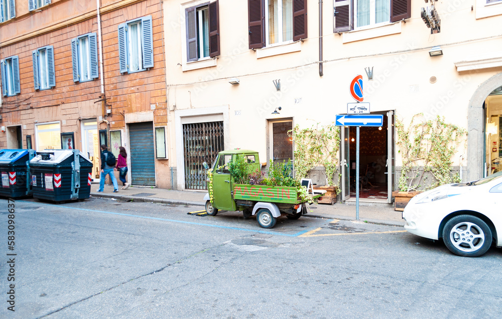 A small truck that is a mobile flower shop in central Rome, Italy.
