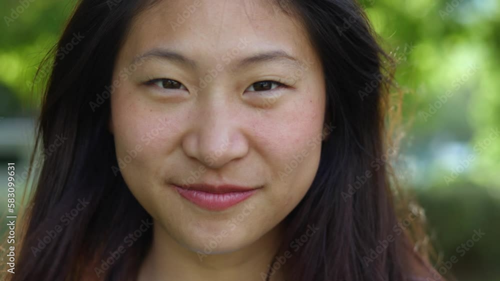 Close-up portrait of happy young teenage asian girl smiling at camera outdoors. Happy people concept Close-up portrait of happy young teenage asian girl smiling at camera outdoors. Happy people concept