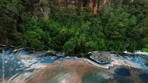 Belmore Falls, Australia, Drone Slowly Pans Down over Waterfall Edge photo