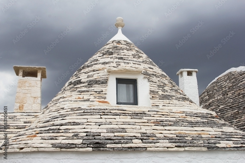 Rooftop of traditional Trulli house and thunderstorm is coming, Alberobello, Puglia, Italy