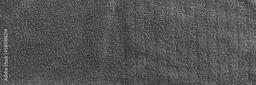 Gray terry towel fabric texture banner. Textile background, top view panoramic web header. Wide screen wallpaper