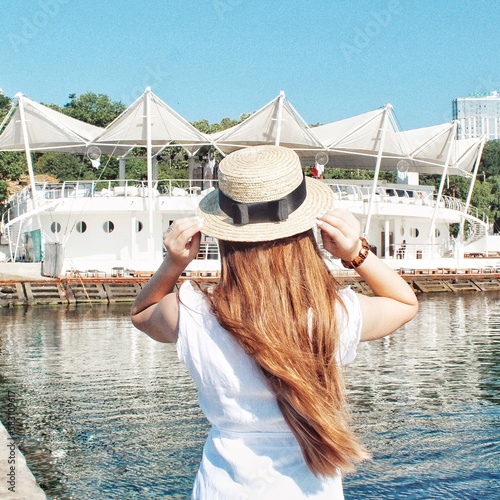 woman in a hat on the pier