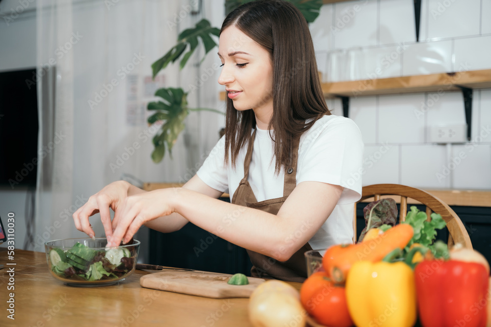 Woman preparing healthy food in her kitchen. Woman preparing healthy food in her kitchen.