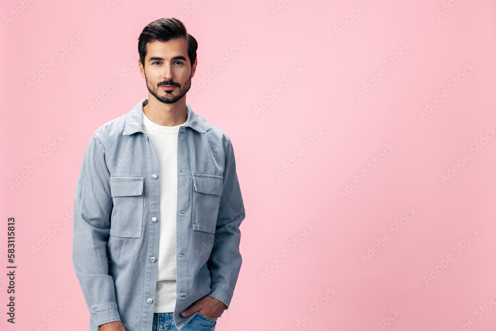 Portrait of a stylish brunette man with a beard beautiful smile on a pink background in a white T-shirt and jeans smile and joyful emotion on his face, copy space Portrait of a stylish brunette man with a beard beautiful smile on a pink background in a white T-shirt and jeans smile and joyful emotion on his face, copy space