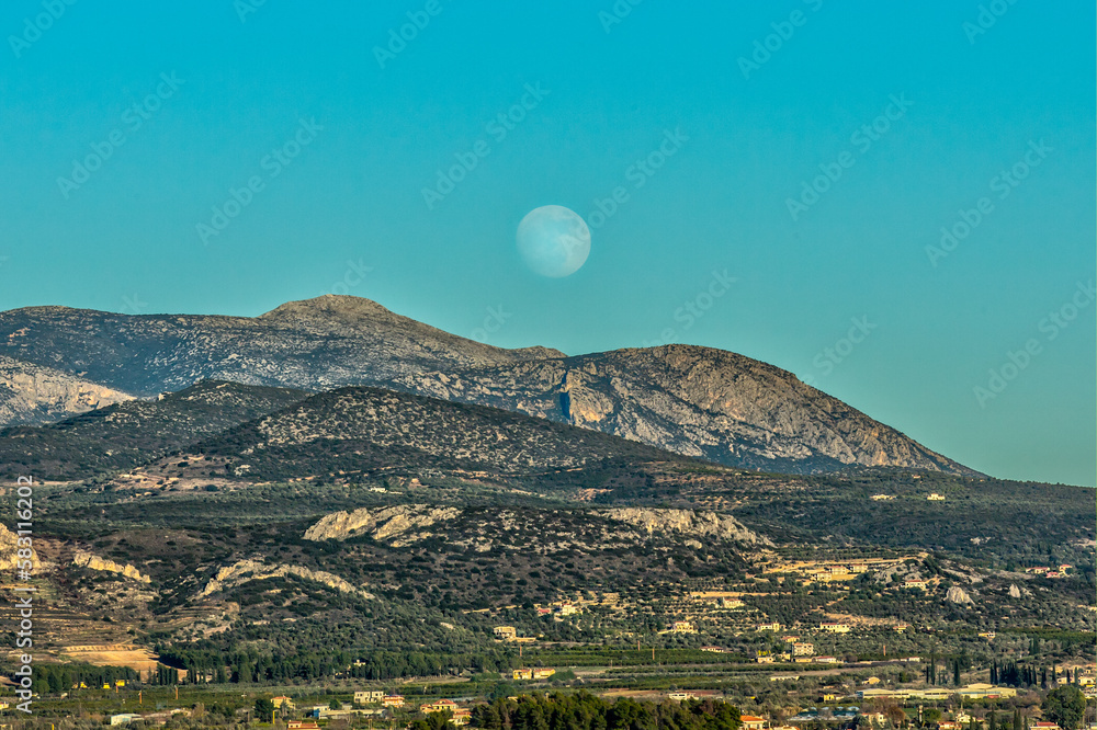 landscape with mountains, full moon  and sky