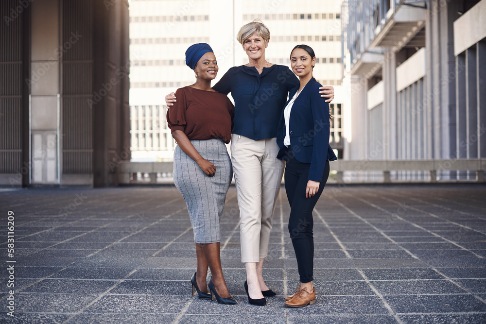 Our team is our source of strength. Portrait of a group of businesswomen standing together against a city background. Our team is our source of strength. Portrait of a group of businesswomen standing together against a city background.