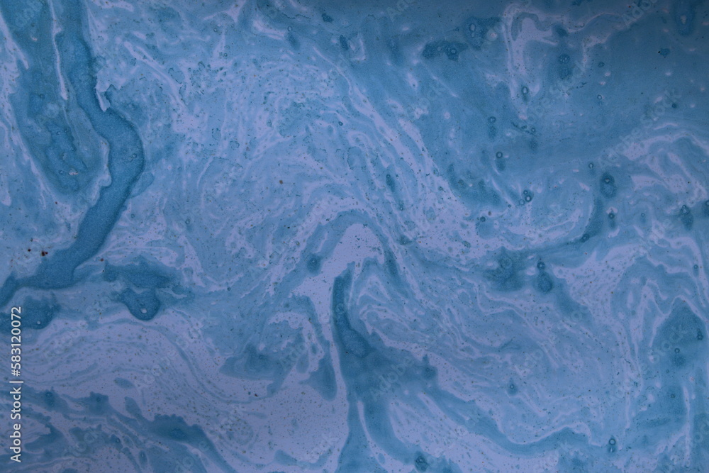 Close up of original beautiful unique marble pattern paper for interior of book cover, abstract design blue colour tones created ancient texture oil paint and turps technique of  mix swirl on water fl