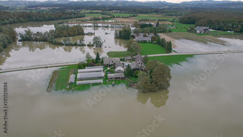 Fotografie AERIAL: Agricultural homesteads on islands in the middle of muddy flood water