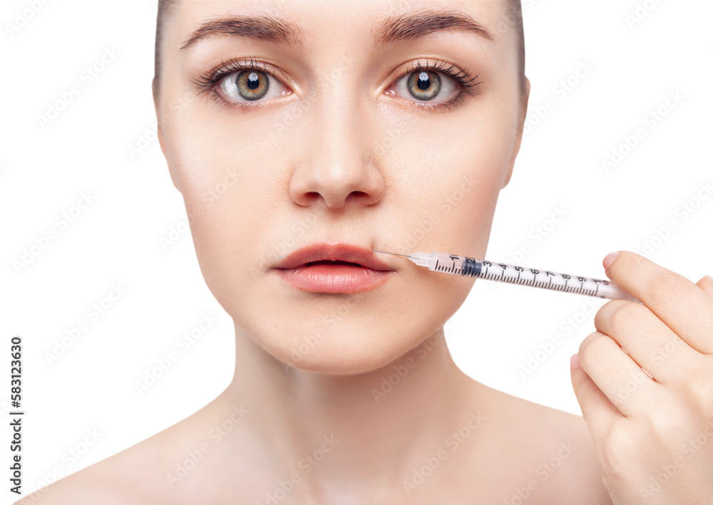 Young woman gets cosmetic injection in lips. Young woman gets cosmetic injection in lips.