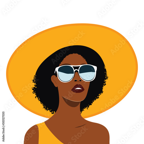 Portrait of a young beautiful black woman in yellow beach outfit wide brimmed sun hat and one-shoulder dress. Fashion summer vacation beauty concept
