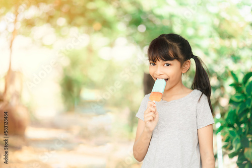 Wallpaper Mural Asia little girl eating ice cream on the nature background with sunlight. Torontodigital.ca