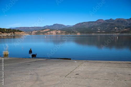 A woman and her dog near the Arizona Roosevelt lake