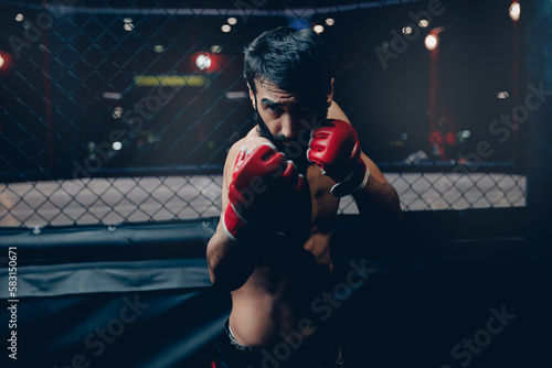 Portrait MMA Fighter, man Preparing red gloves for training before sparring in cage octagon