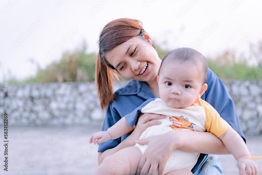 Asian woman holding a baby close up, mother holding baby with love. Asian woman holding a baby close up, mother holding baby with love.