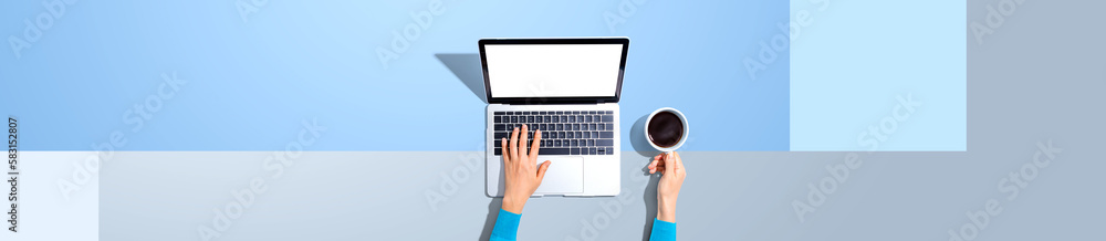 Person using a laptop computer from above Person using a laptop computer from above