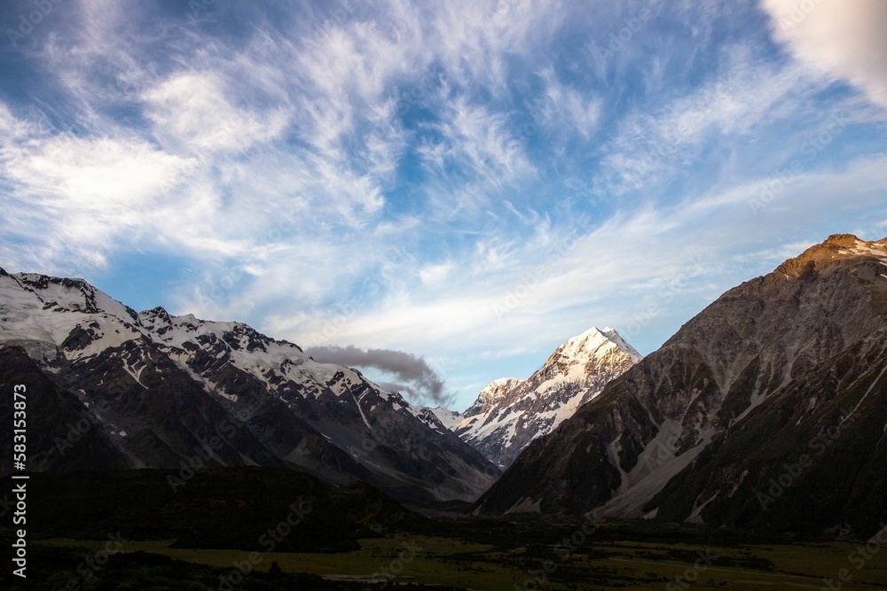 Picturesque landscape featuring snow-capped mountains bathed in sunlight in New Zealand